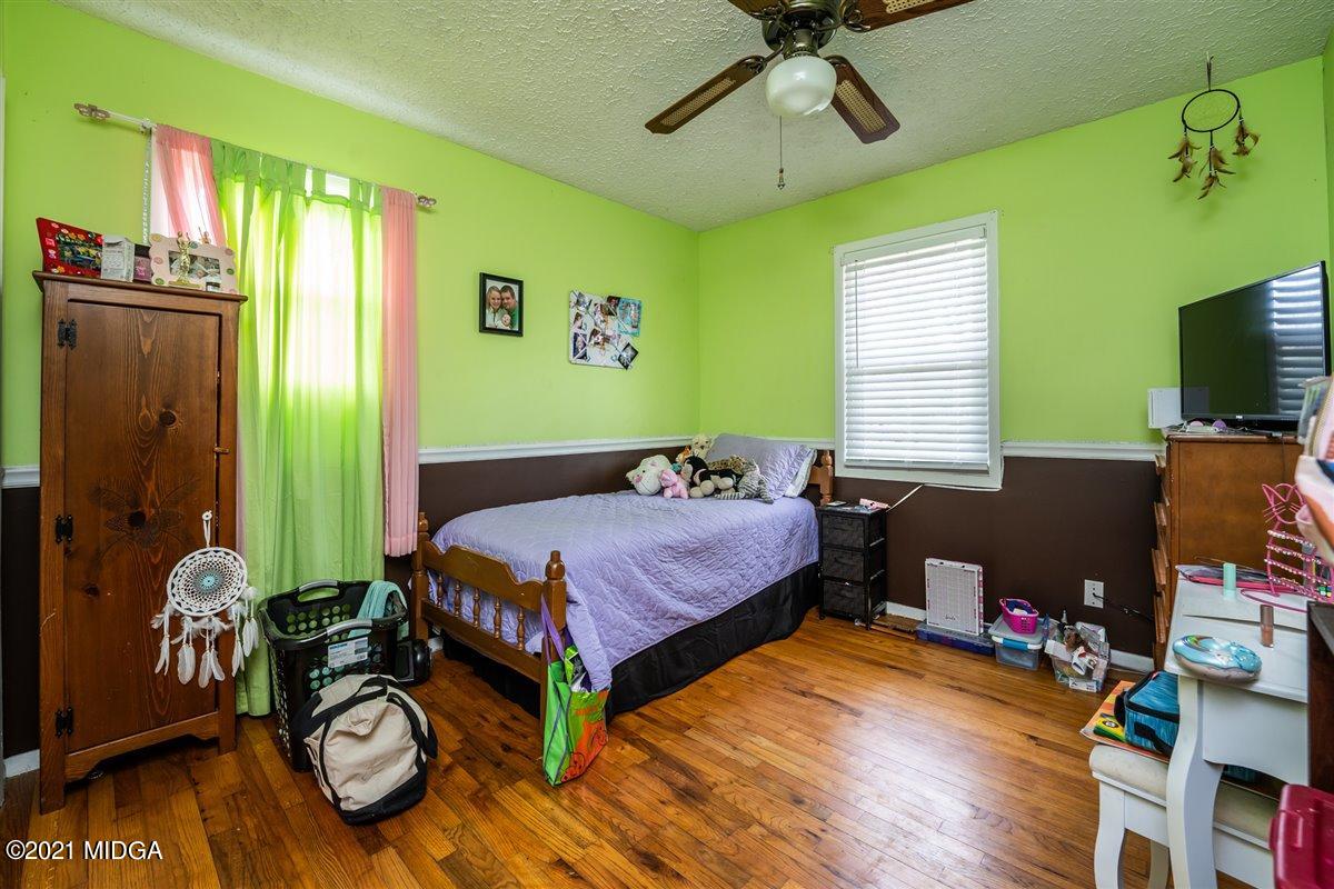 2805 South Estates Road Macon, GA 31216 - Photo 12 of 17 a bedroom with a bed and wooden floor
