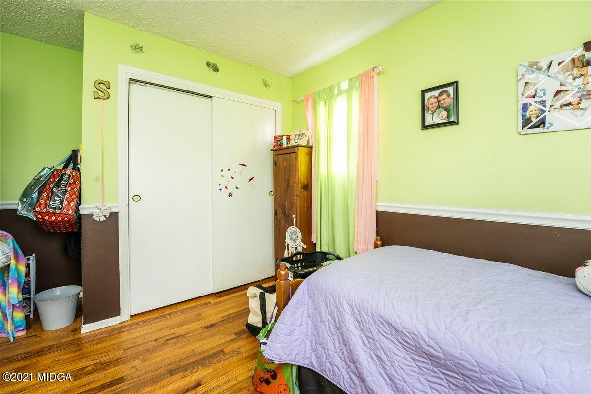 2805 South Estates Road Macon, GA 31216 - Photo 13 of 17 a bedroom with a bed and wooden floor
