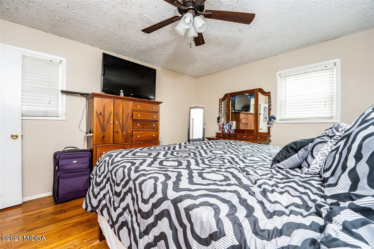 2805 South Estates Road Macon, GA 31216 - Photo 14 of 17 a bedroom with a bed television on desk and a window