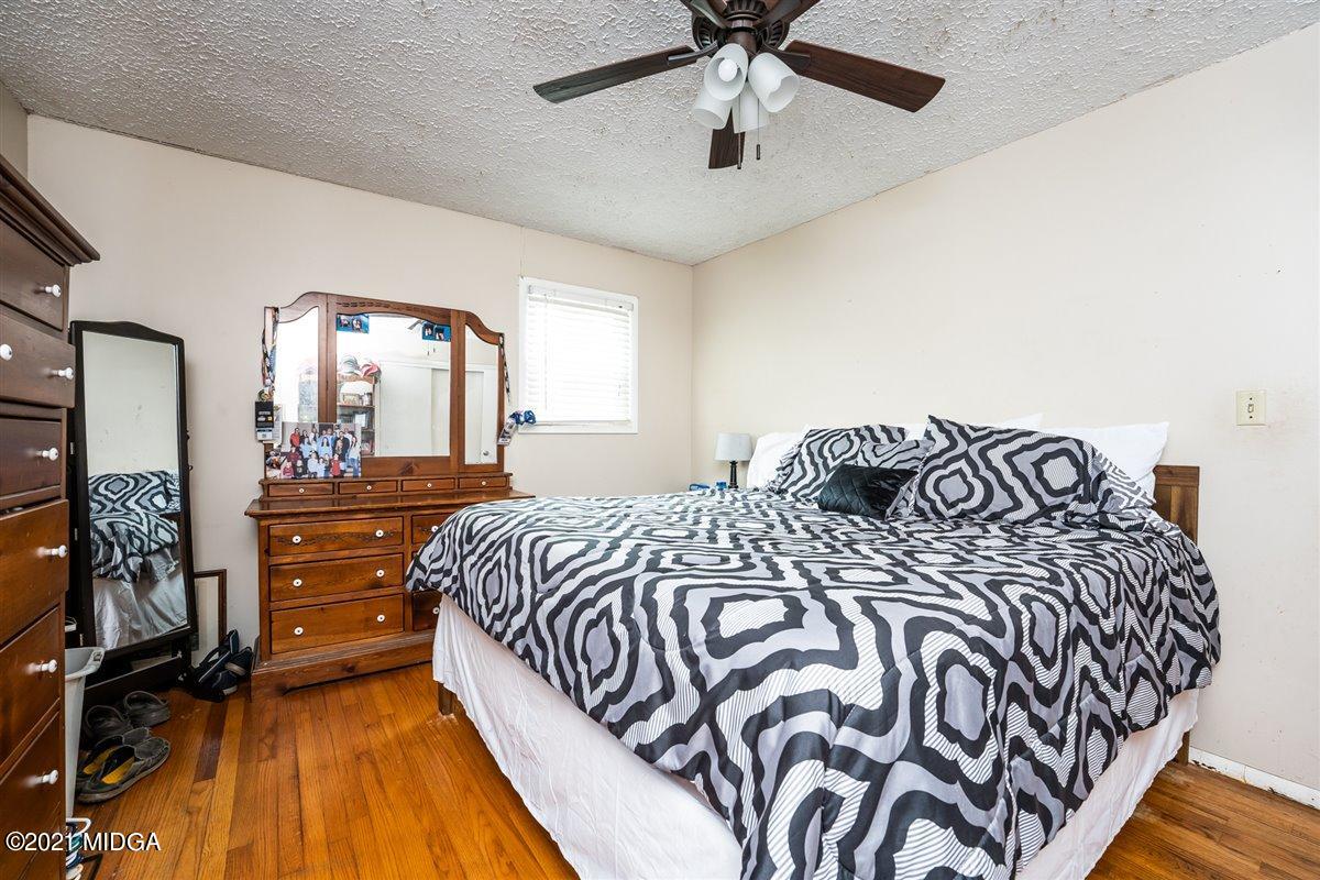 2805 South Estates Road Macon, GA 31216 - Photo 15 of 17 a bedroom with a bed and a mirror