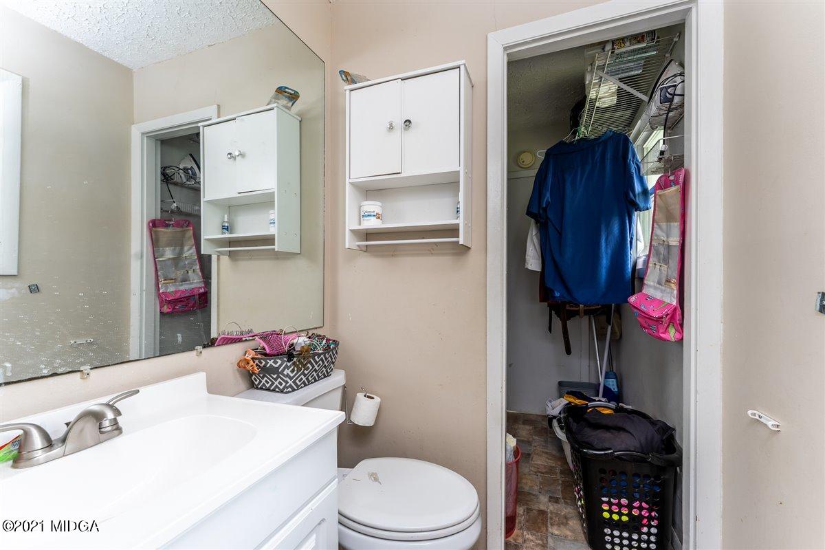 2805 South Estates Road Macon, GA 31216 - Photo 16 of 17 a bathroom with a sink vanity mirror and toilet
