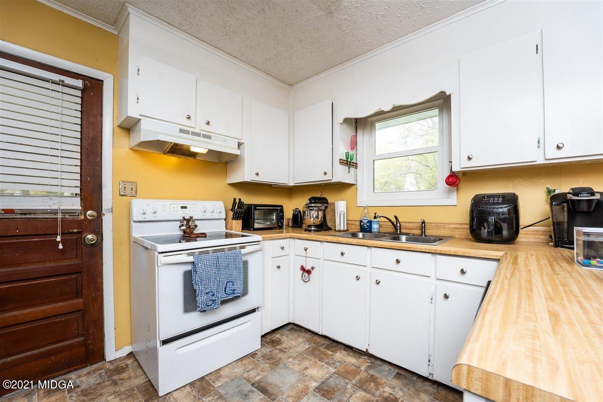 2805 South Estates Road Macon, GA 31216 - Photo 7 of 17 a kitchen with a sink a stove and cabinets