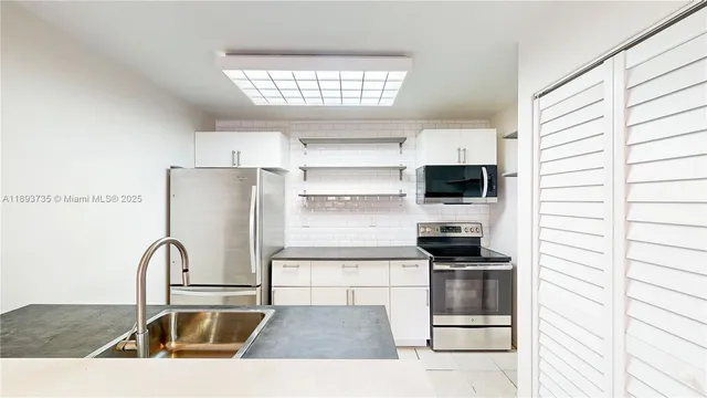 a kitchen with a sink and a refrigerator
