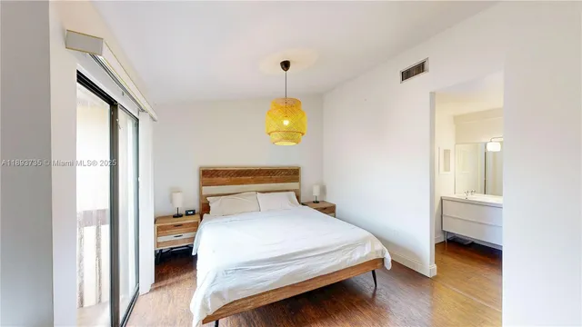 a view of a room with wooden floor and windows