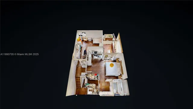 an aerial view of a house with a yard and a bench