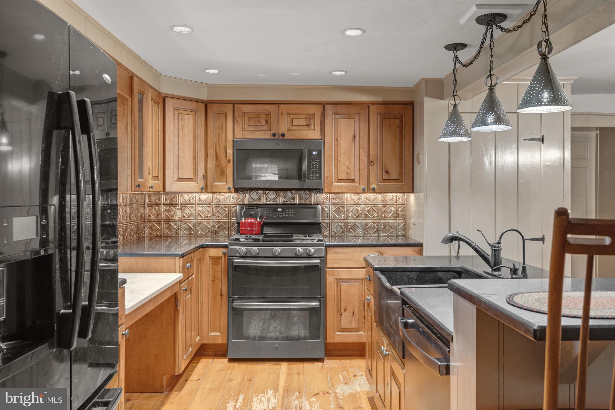 1592 White Oak Road Strasburg, PA 17579 - Photo 13 of 68 a kitchen with kitchen island granite countertop a sink stainless steel appliances and cabinets