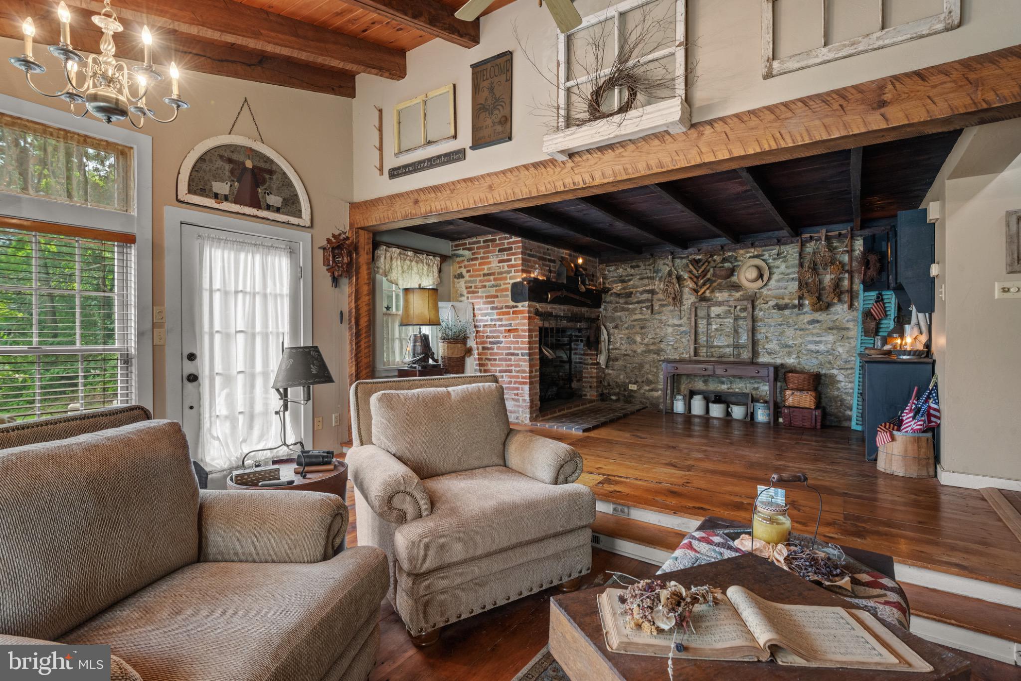 1592 White Oak Road Strasburg, PA 17579 - Photo 24 of 68 a living room with furniture a fireplace and lots of windows