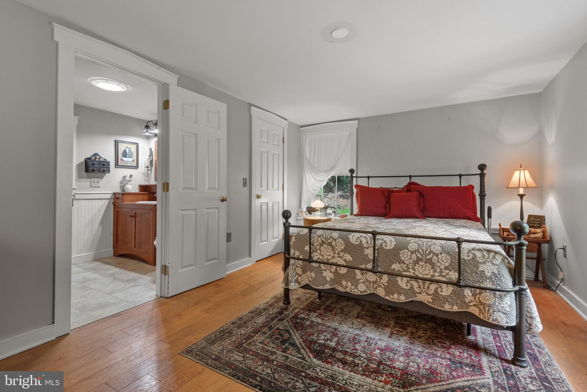 1592 White Oak Road Strasburg, PA 17579 - Photo 29 of 68 a bedroom with a bed and wooden floor