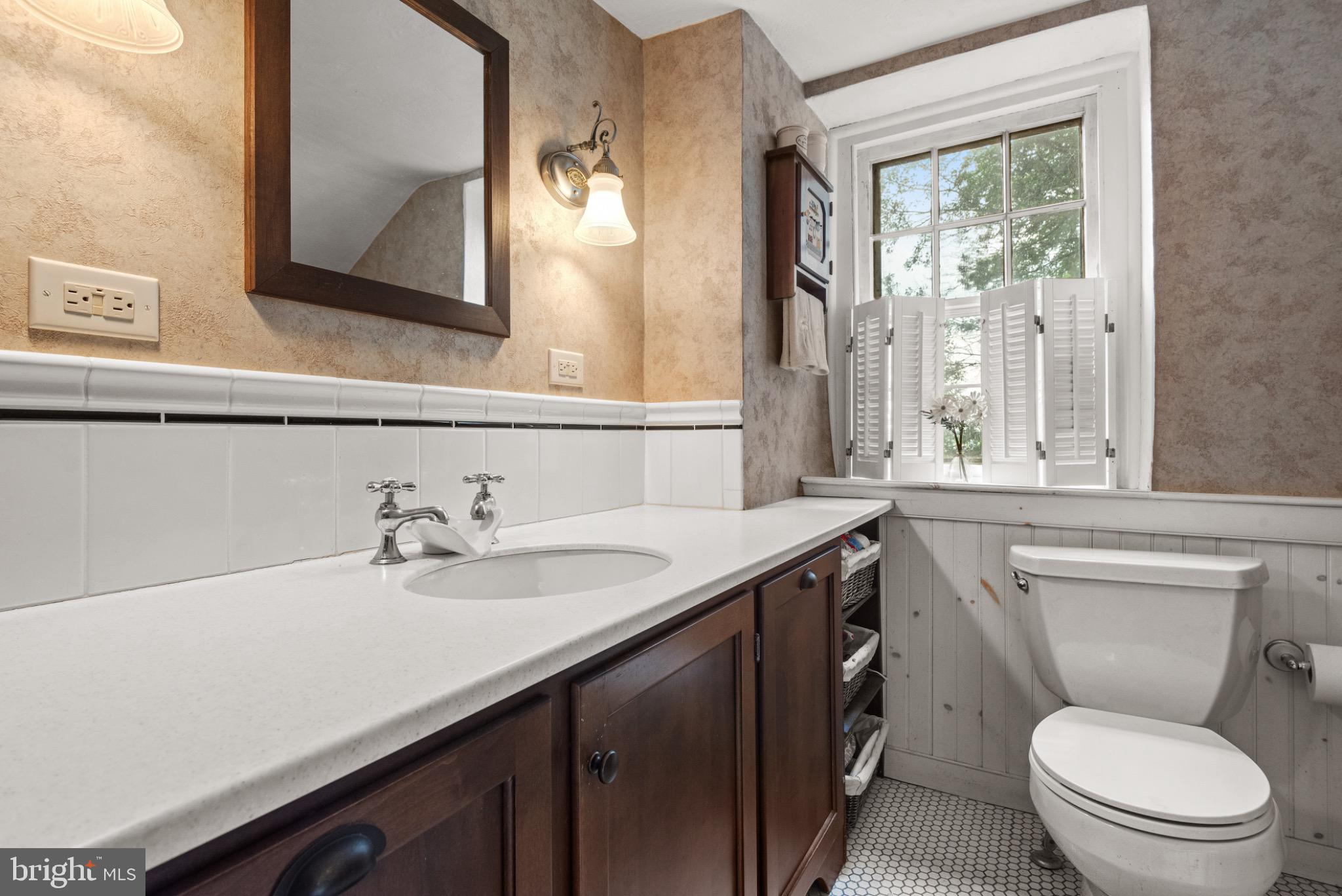 1592 White Oak Road Strasburg, PA 17579 - Photo 37 of 68 a bathroom with a granite countertop toilet sink and mirror
