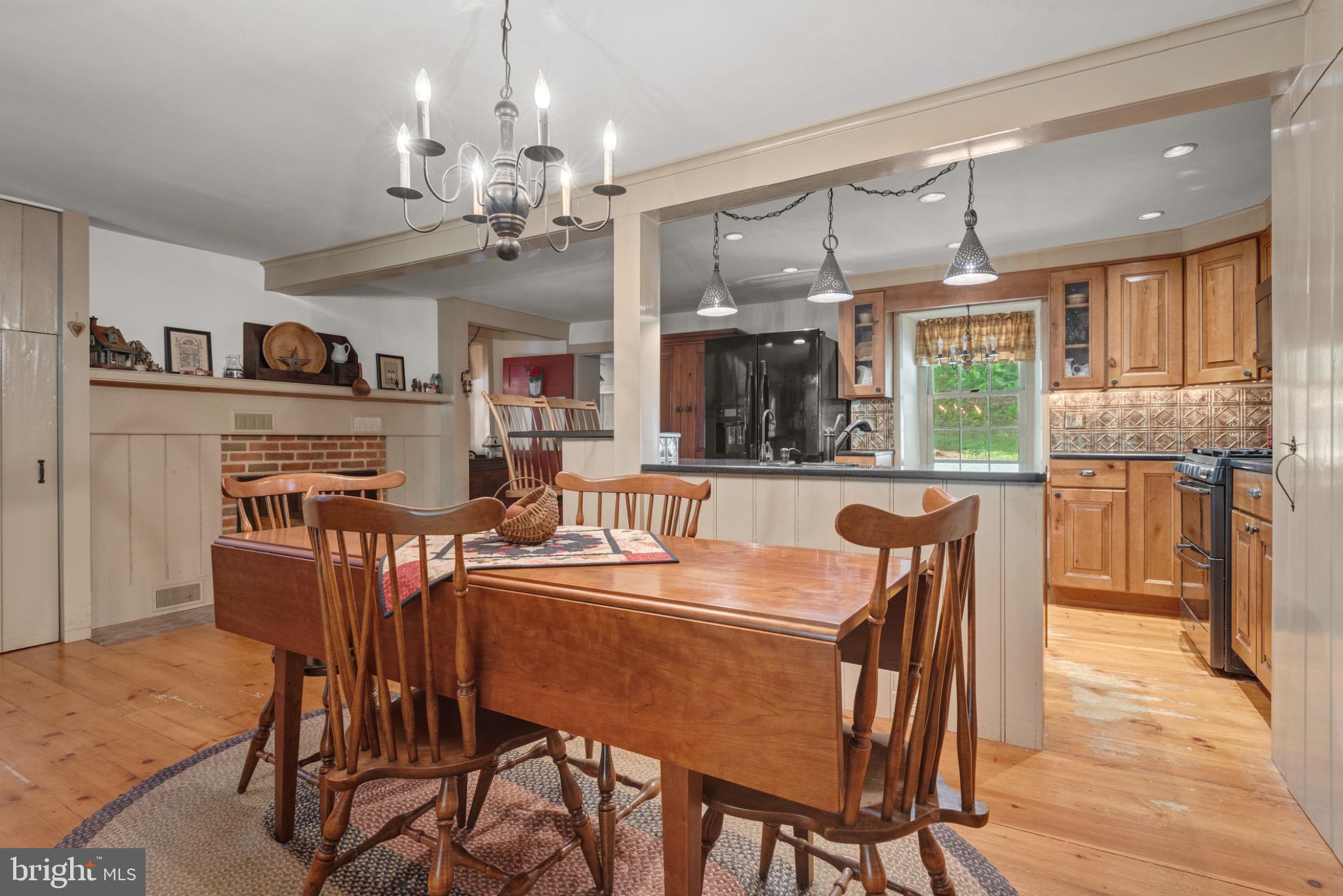 1592 White Oak Road Strasburg, PA 17579 - Photo 10 of 68 a dining room filled chandelier and wooden floor