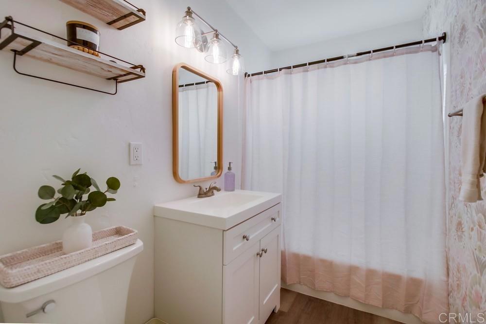 12930 Morene Street Poway, CA 92064 - Photo 26 of 26 a bathroom with a sink a mirror and a shower curtain
