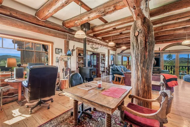a view of a dining room with furniture a chandelier and wooden floor