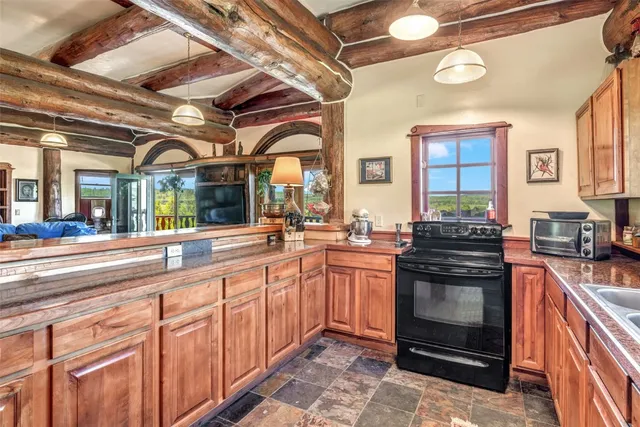 a kitchen with stainless steel appliances a stove sink and wooden cabinets