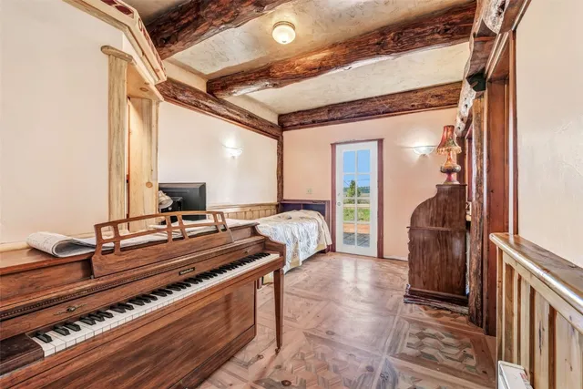 a bed sitting in a bedroom next to a window