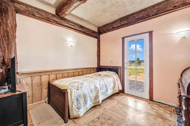 a bedroom with a bed and a flat screen tv