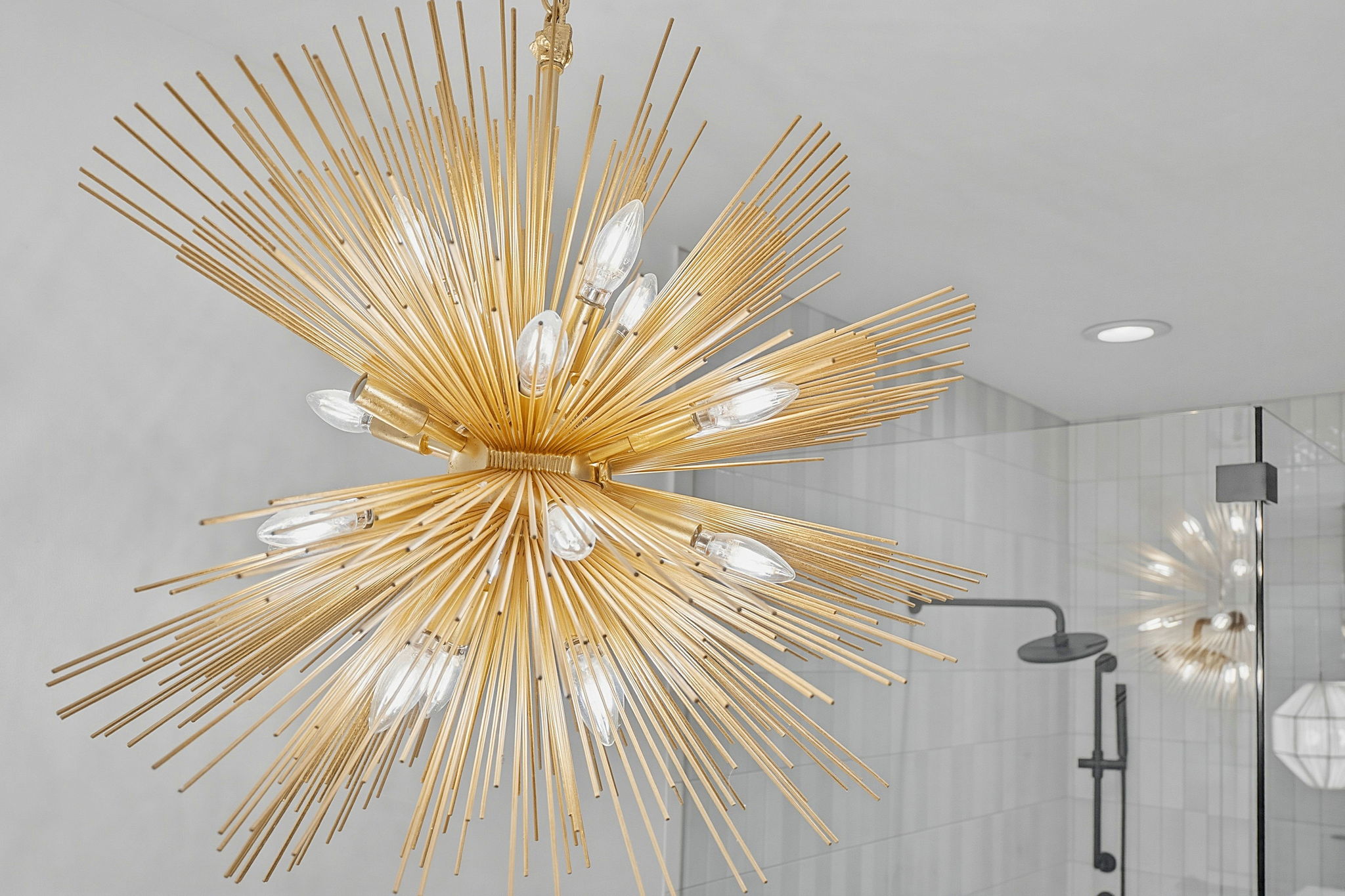 2004 Riverview Street Austin, TX 78702 - Photo 25 of 36 Brass sputnik chandelier illuminating a glass-enclosed shower with matte black fixtures and light gray tile