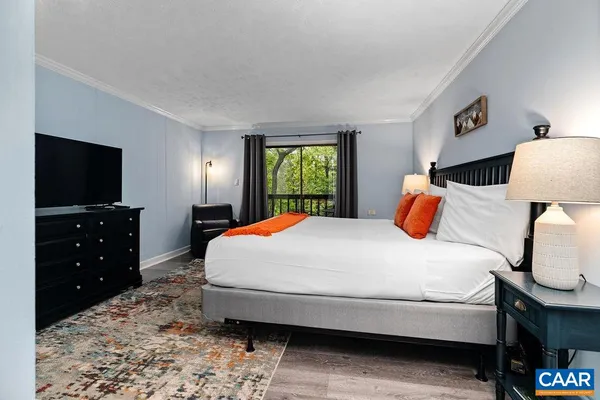 a bedroom with a bed and a flat screen tv