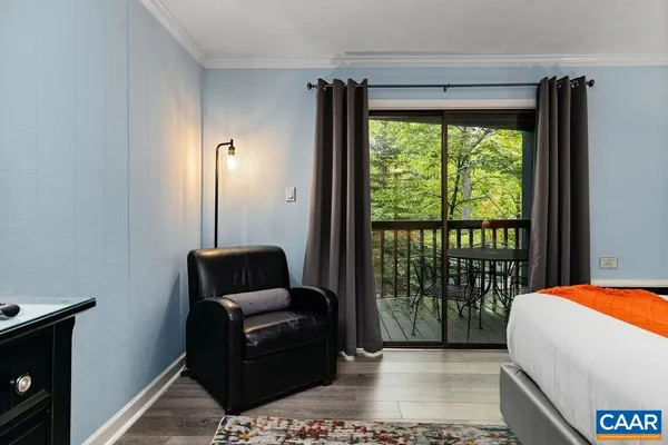 a bedroom with a bed and glass window