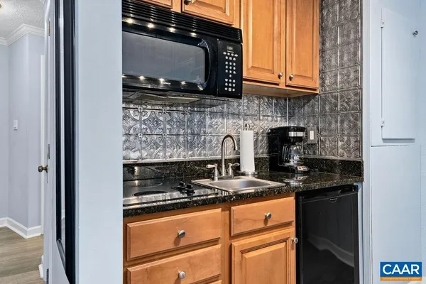 a kitchen with stainless steel appliances granite countertop a stove and a microwave