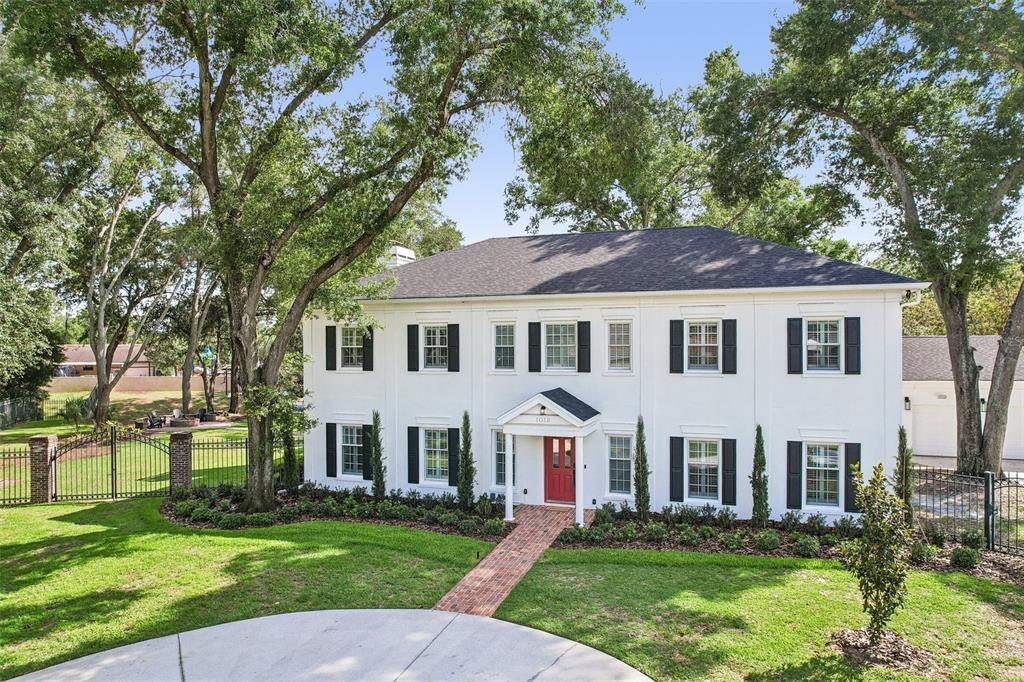 1012 Morfield Lane Brandon, FL 33511 - Photo 4 of 100 a view of a white house with a yard and a large tree