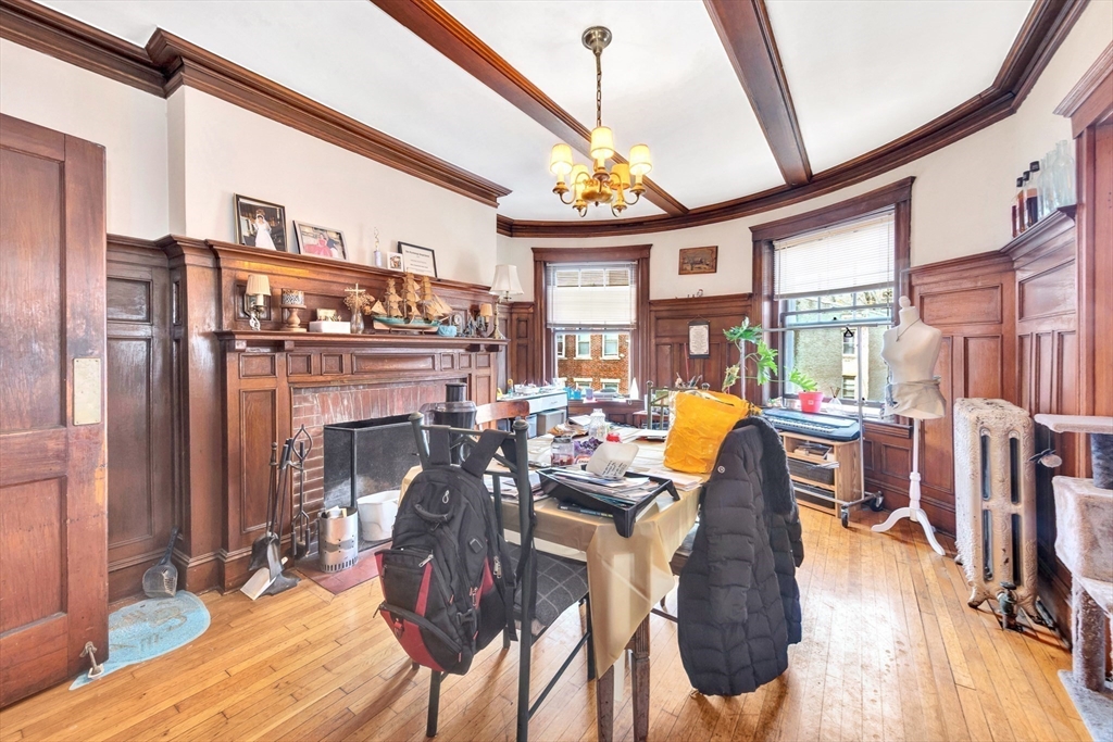 106 Strathmore Road Boston, MA 02135 - Photo 11 of 30 a view of a dining room with furniture one side kitchen view and wooden floor