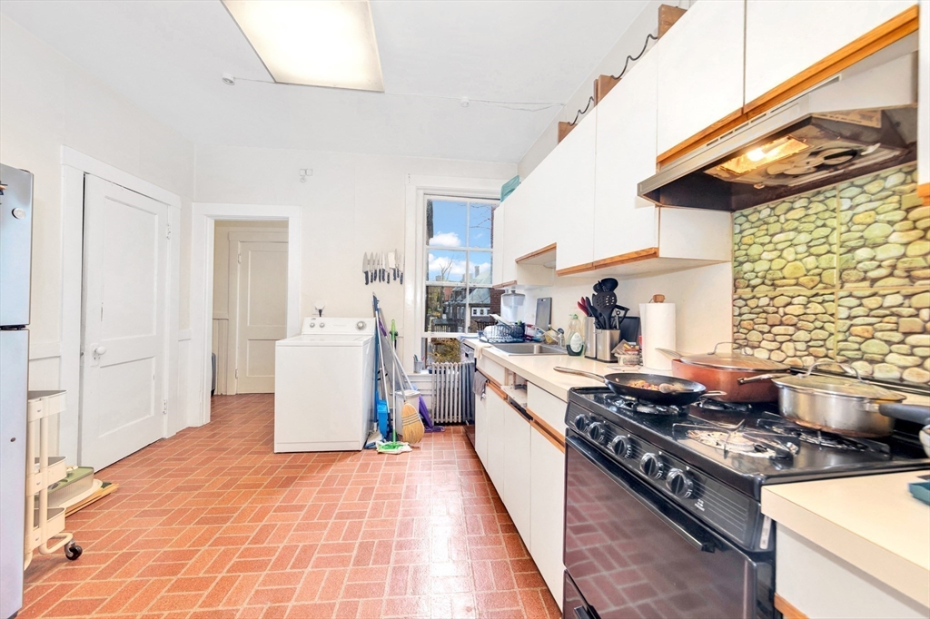 106 Strathmore Road Boston, MA 02135 - Photo 13 of 30 a kitchen with a stove and a refrigerator