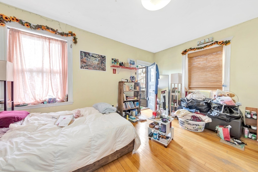 106 Strathmore Road Boston, MA 02135 - Photo 17 of 30 a bedroom with bed and large window