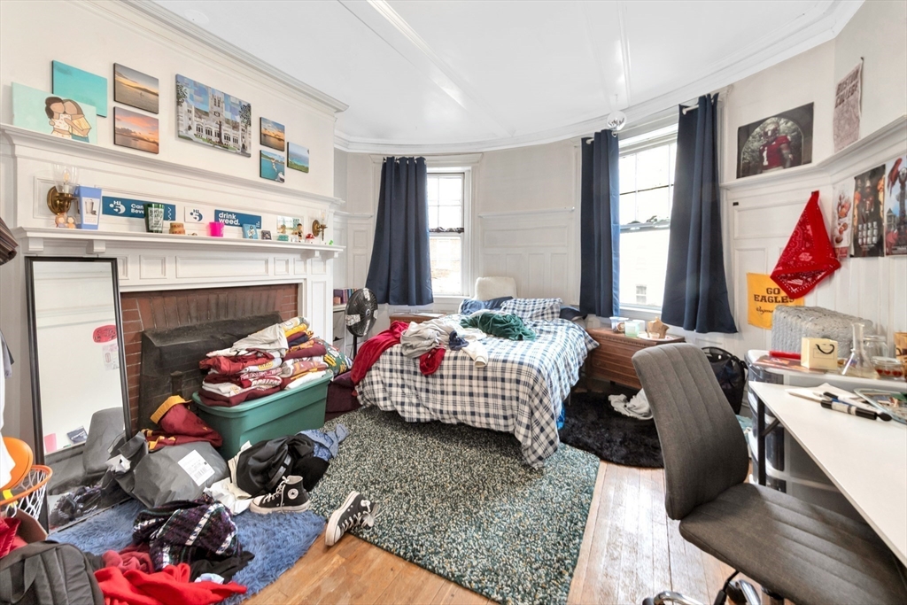 106 Strathmore Road Boston, MA 02135 - Photo 19 of 30 a bedroom with furniture and a fireplace