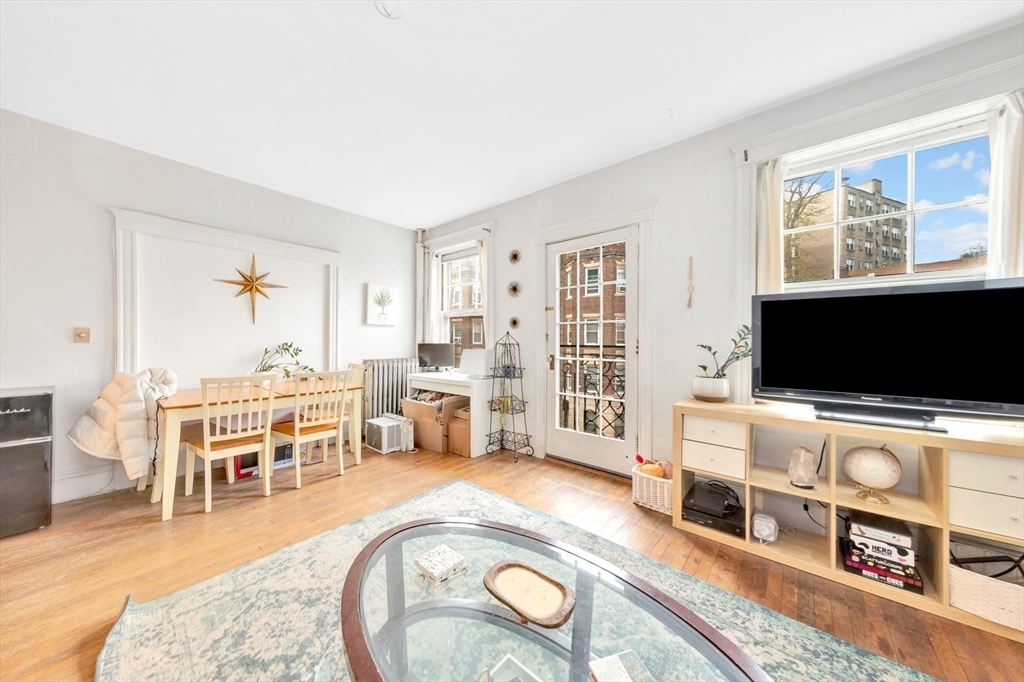 106 Strathmore Road Boston, MA 02135 - Photo 21 of 30 a living room with furniture and a flat screen tv