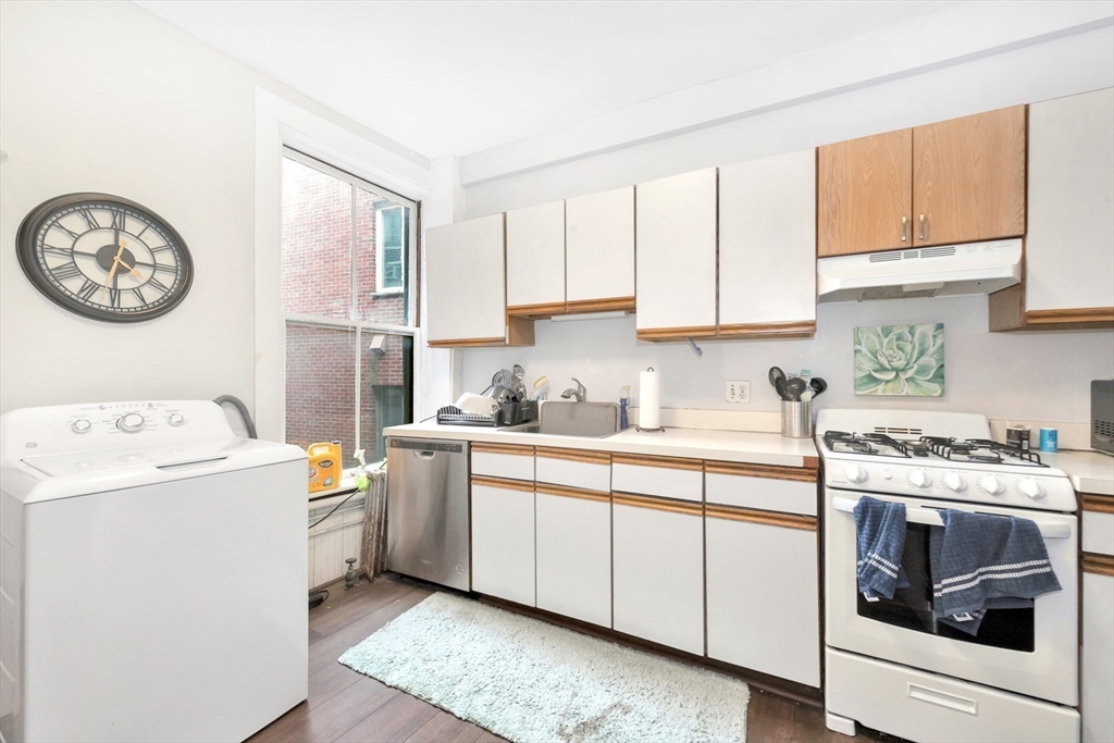 106 Strathmore Road Boston, MA 02135 - Photo 23 of 30 a kitchen with a stove and a sink