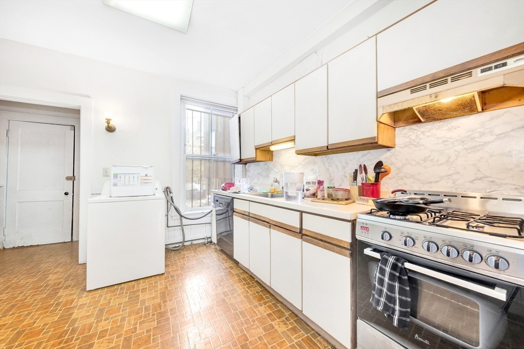 106 Strathmore Road Boston, MA 02135 - Photo 6 of 30 a kitchen with a stove a sink and a refrigerator