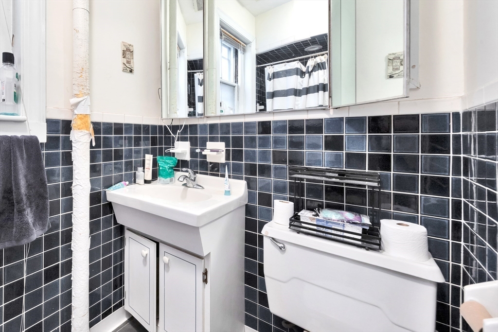 106 Strathmore Road Boston, MA 02135 - Photo 7 of 30 a bathroom with a sink a toilet and shower