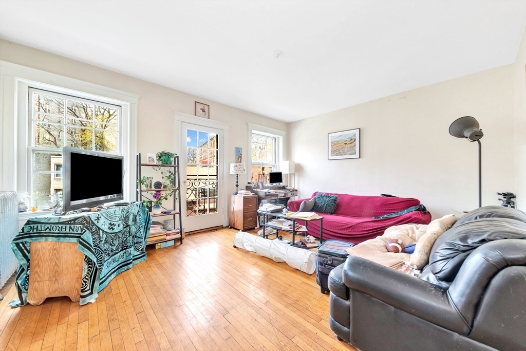106 Strathmore Road Boston, MA 02135 - Photo 9 of 30 a living room with furniture and a flat screen tv