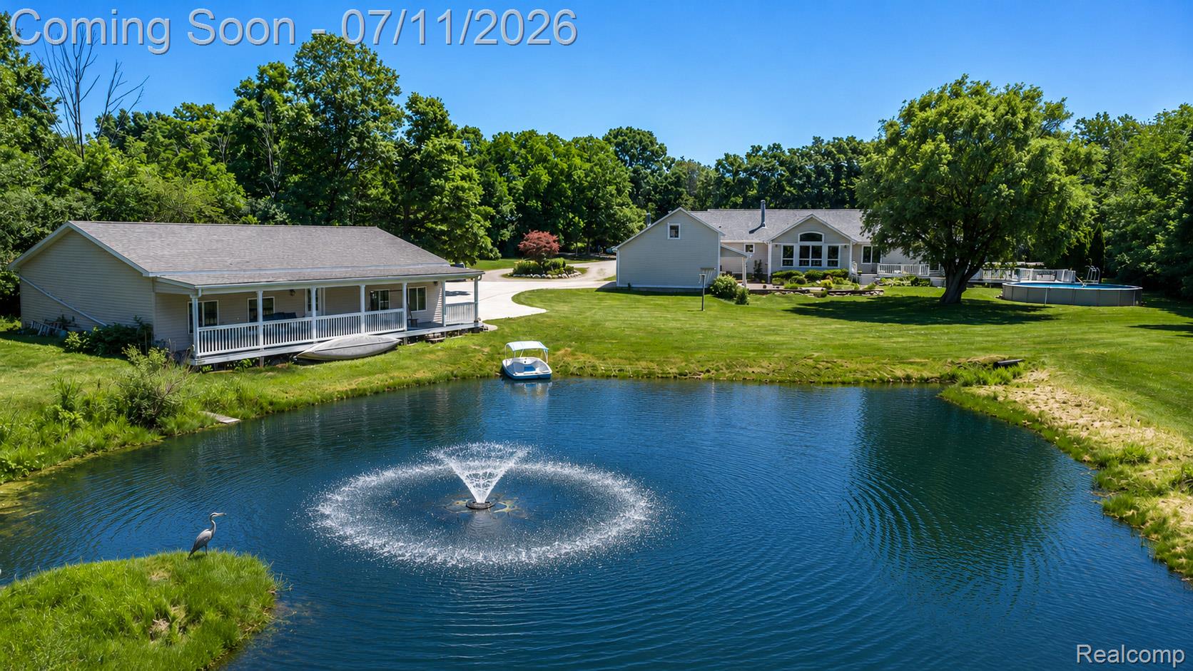2120 Montague Road Davison, MI 48423 - Photo 5 of 37 Expansive property featuring a tranquil pond with a fountain, surrounded by mature trees