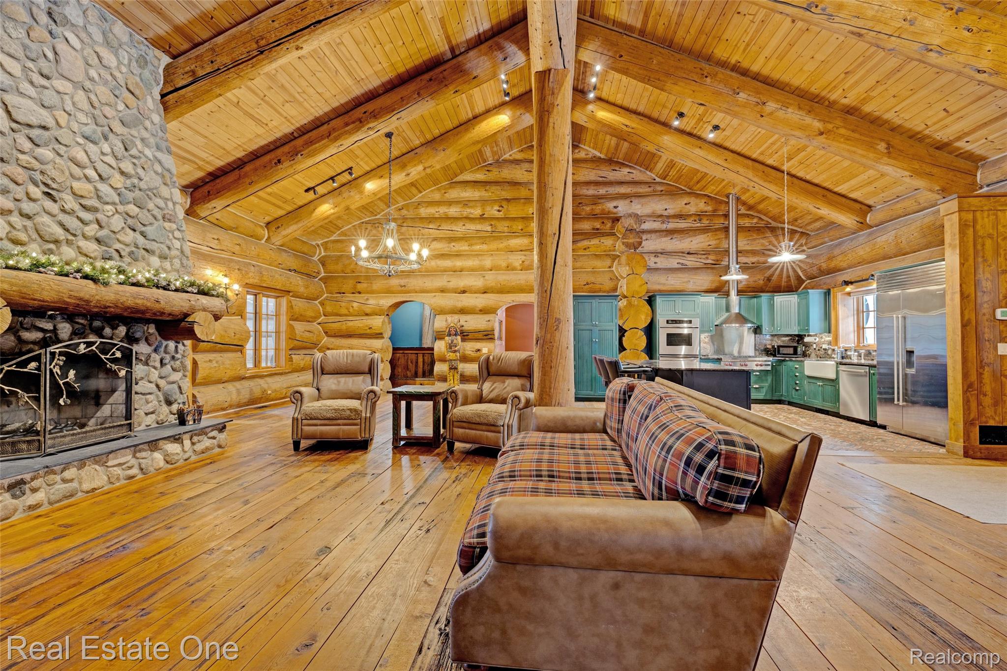 4340 Lahring Road Holly, MI 48442 - Photo 7 of 89 Living room featuring log walls, light wood finished floors, a wood ceiling with exposed beams, a fireplace, and high vaulted ceiling