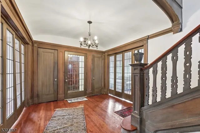 a view of a bedroom with wooden floor and windows