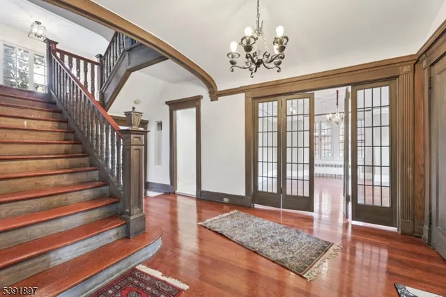 a view of entryway and hall with wooden floor