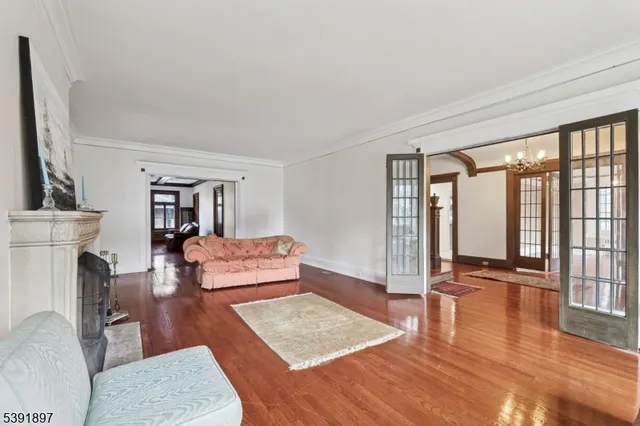 a bedroom with furniture and a large window