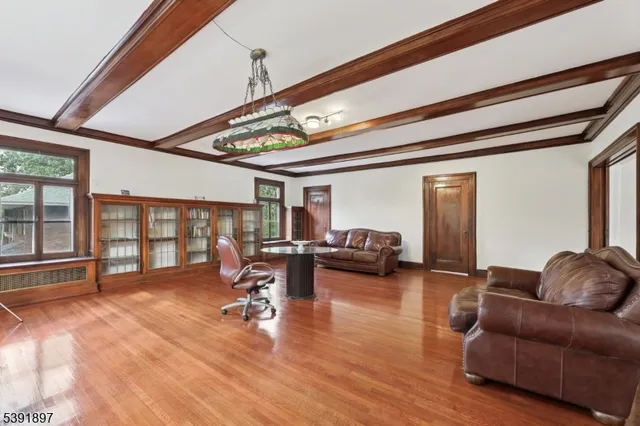 a living room with furniture gym equipment and a large window