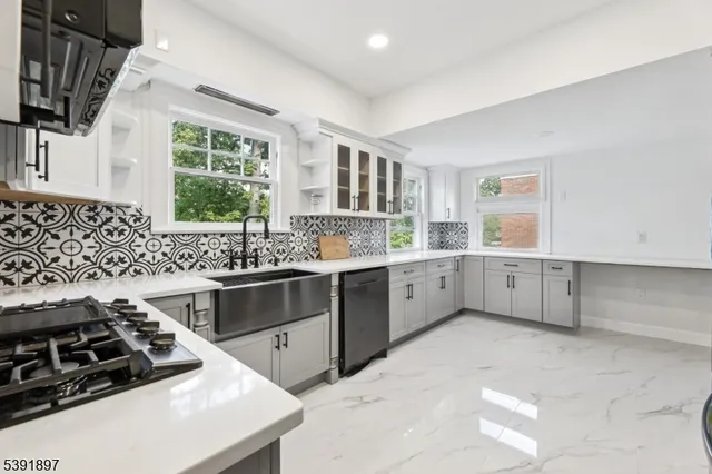 a kitchen with a stove a sink and a refrigerator