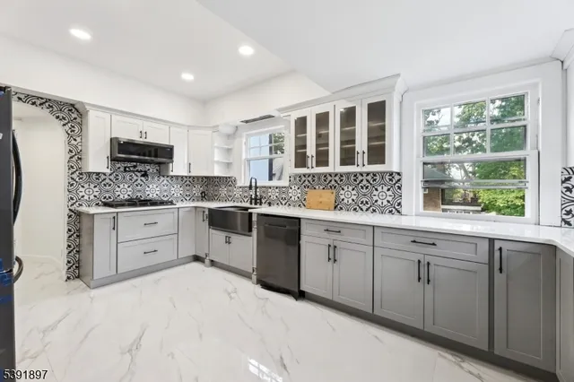 a kitchen with a sink stove and cabinets