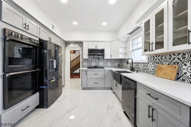 a kitchen with stainless steel appliances a stove sink and microwave