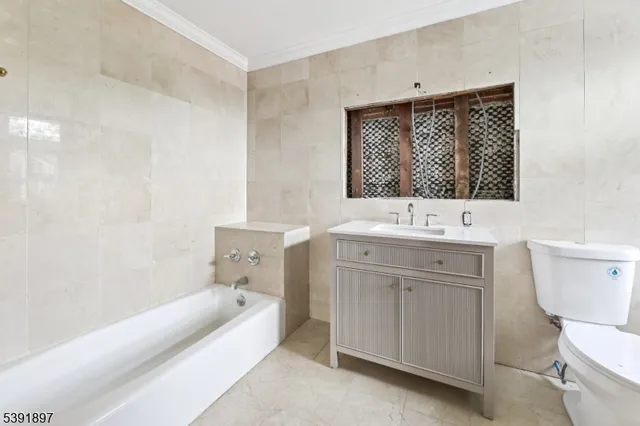 a bathroom with a sink a toilet and bathtub