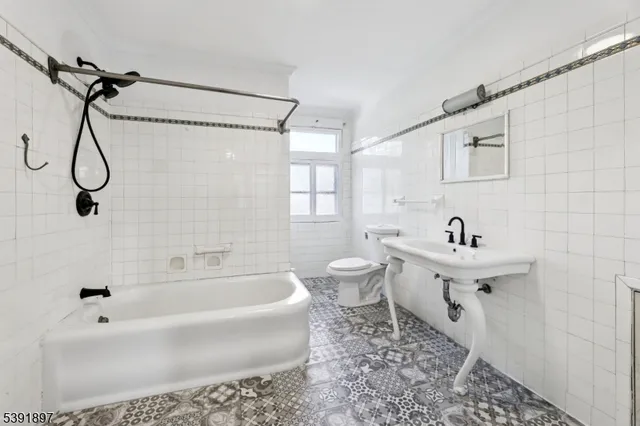 a bathroom with a sink a toilet and a bathtub