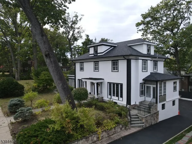 a front view of a house with a garden