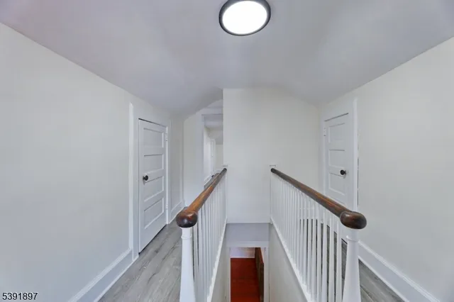 a view of a hallway with stairs