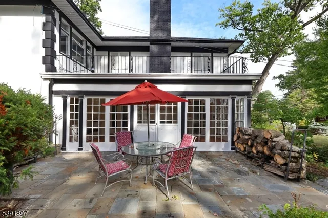 a view of a cafe with a table and chairs under an umbrella
