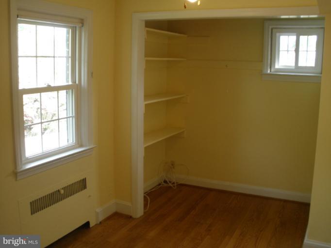 321 Dunkirk Road Baltimore, MD 21212 - Photo 13 of 30 a view of an empty room with a window and wooden floor