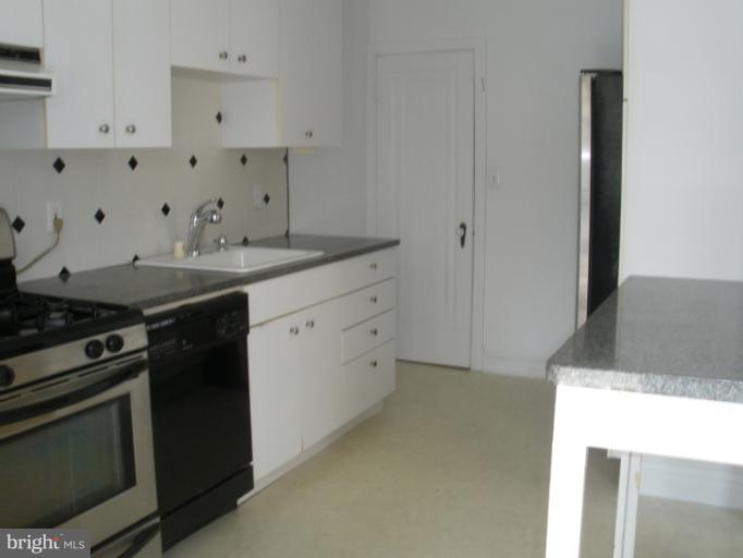 321 Dunkirk Road Baltimore, MD 21212 - Photo 18 of 30 a kitchen with stainless steel appliances granite countertop a sink stove and cabinets
