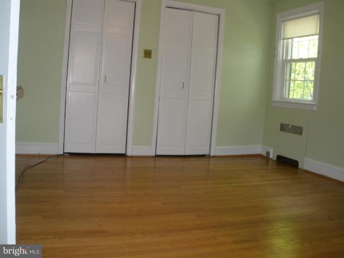 321 Dunkirk Road Baltimore, MD 21212 - Photo 3 of 30 an empty room with wooden floor and windows